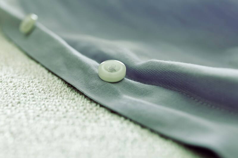 How to sew a button on a shirt?